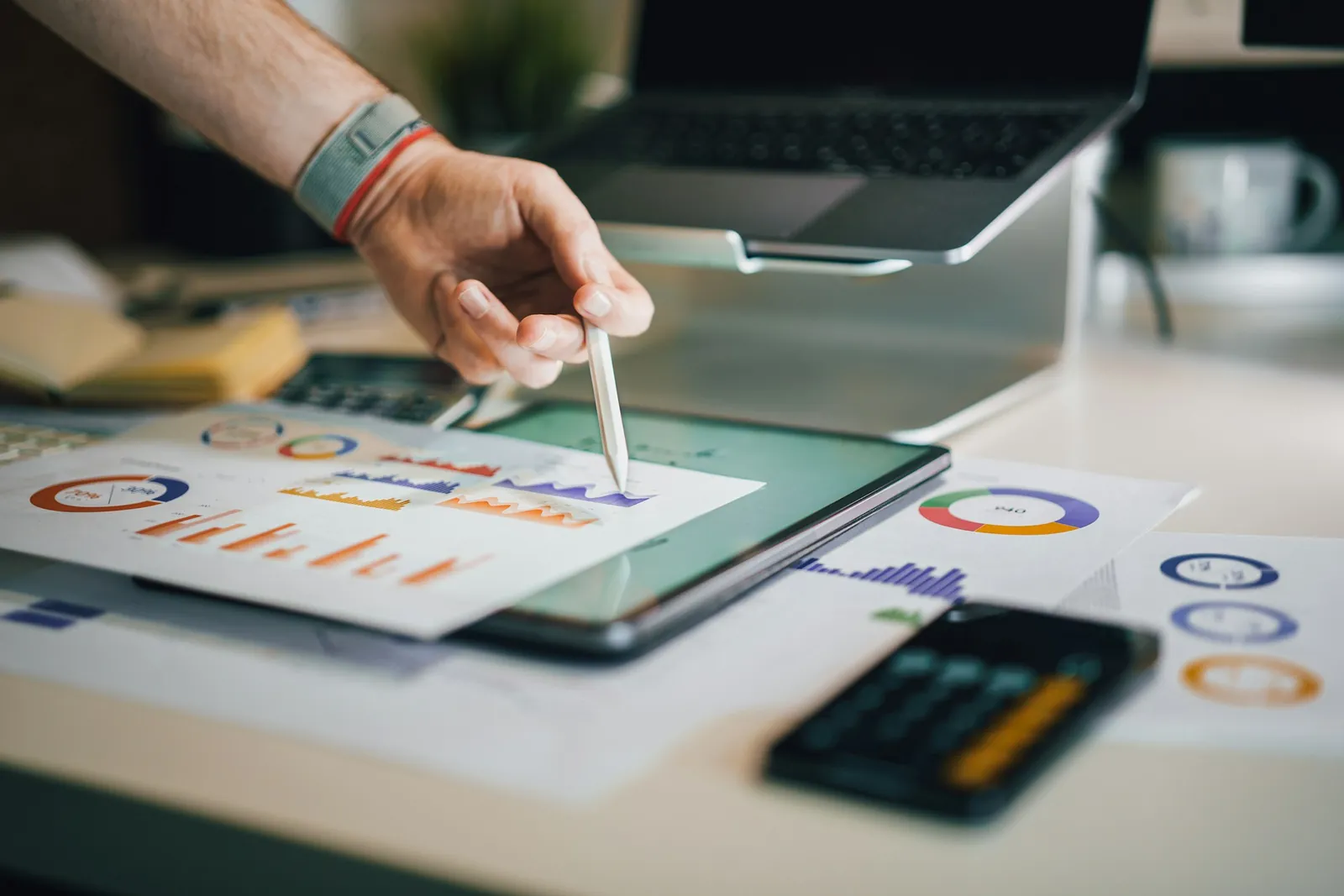 Analyst reviewing market charts on a tablet